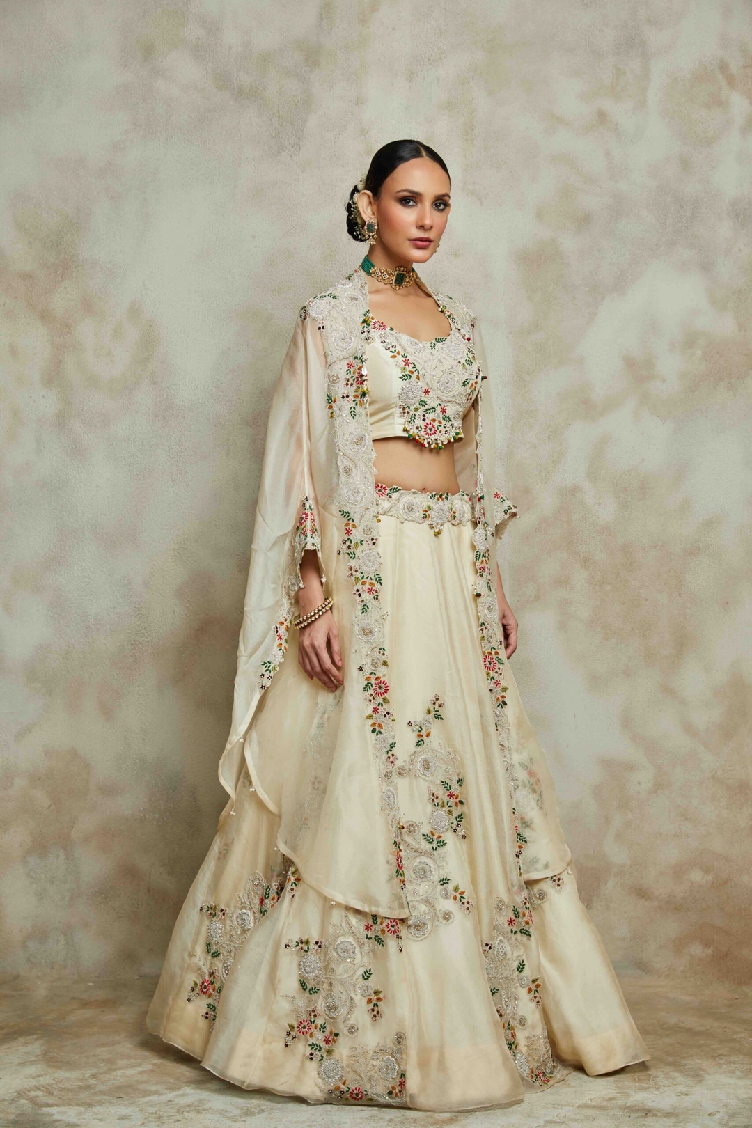 Ivory silk blouse with organza cape and lehenga