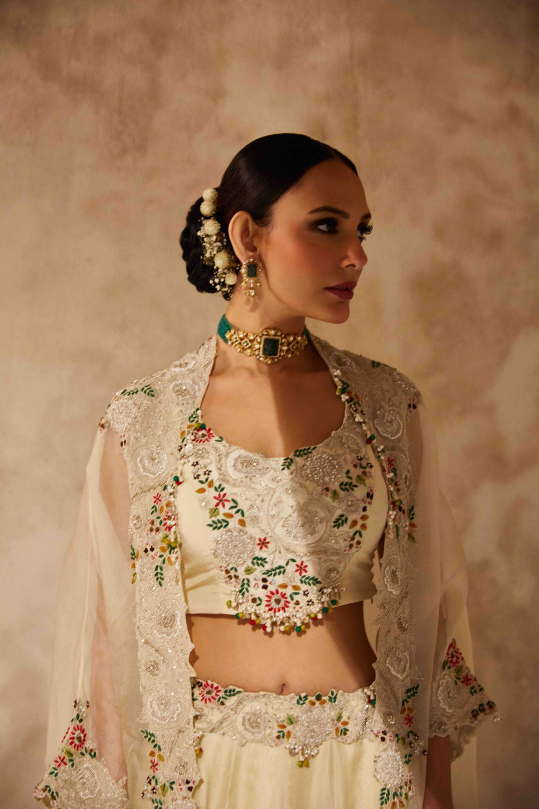 Ivory silk blouse with organza cape and lehenga